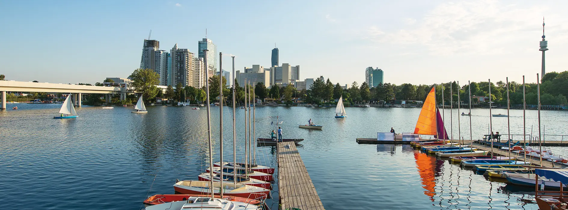 Summer day on the Old Danube, boats in the water, Vienna skyline in the background