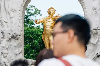 Vienna City Park, Johann Strauss monument, tourists in the foreground