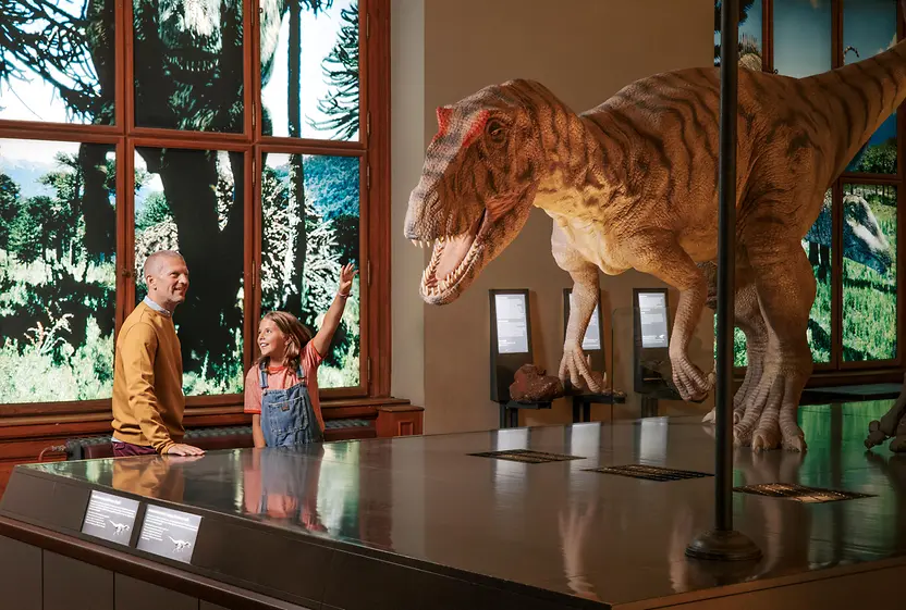 Family in the Naturhistorisches Museum Vienna marvels at dinosaurs